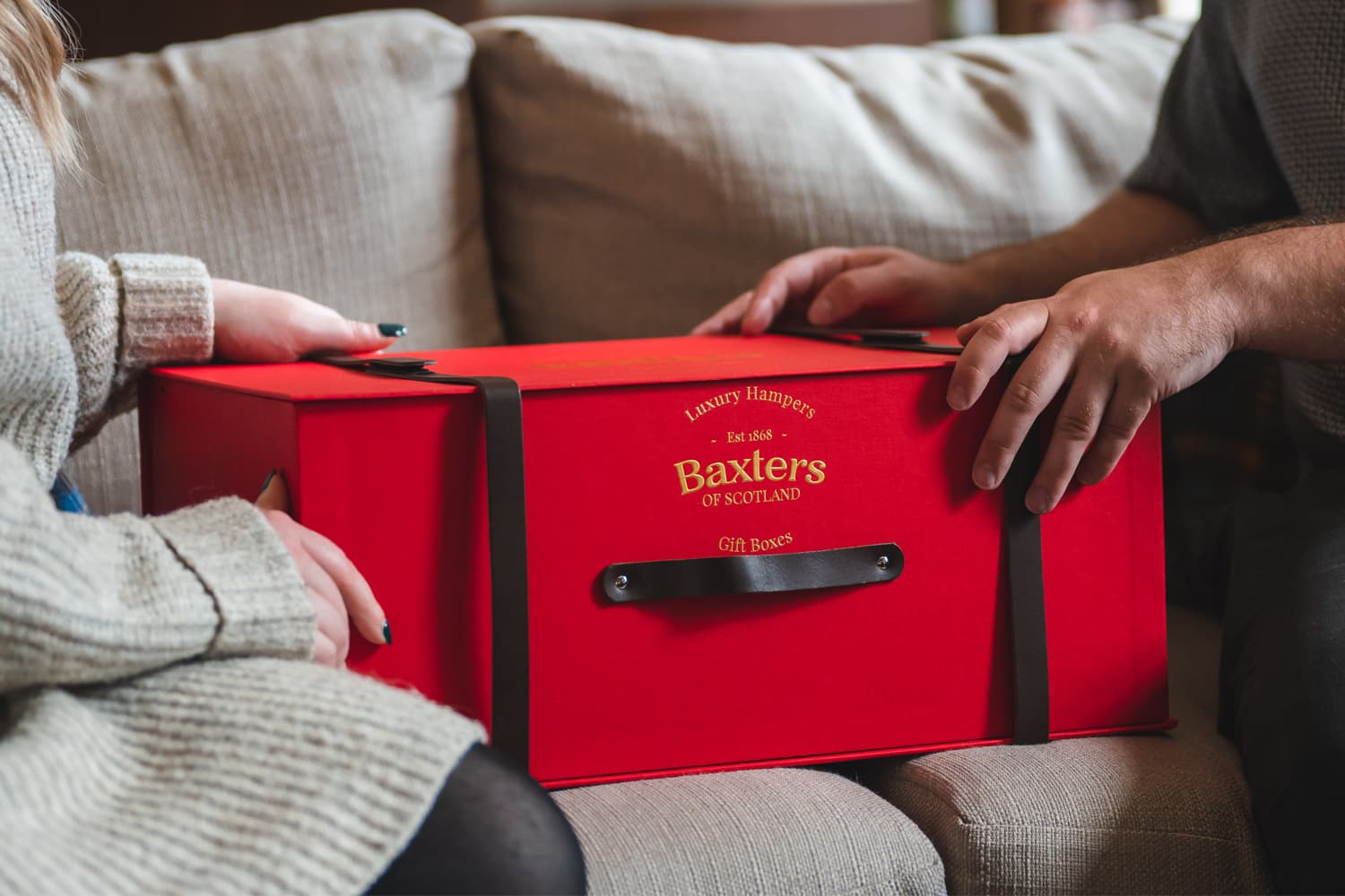 A Baxters Hamper being handed from one person to another